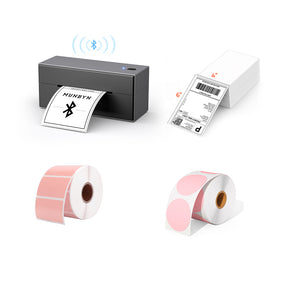 The MUNBYN Bluetooth P129 label printer kit is a comprehensive package that includes a sleek black Bluetooth label printer, as well as a roll of pink rectangular labels, a roll of pink round labels, and a stack of 4x6 thermal labels.